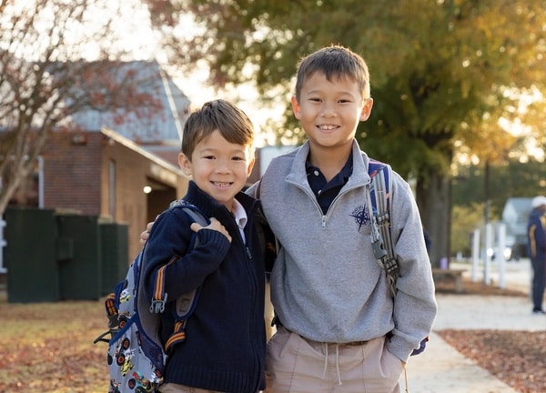 hampton-roads-academy-lower-school brothers hugging outside hampton roads academy lower school