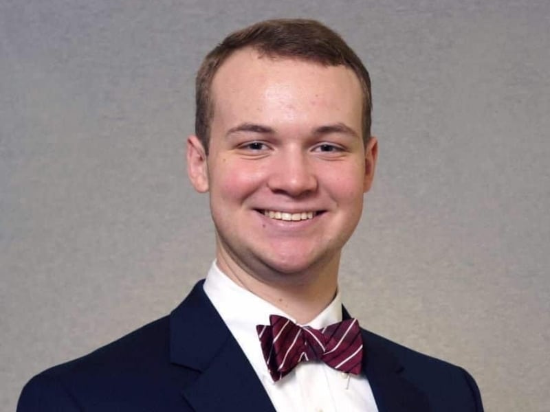 portrait-of-a-graduate-alumni portrait of a graduate young man wearing black suit and bow tie