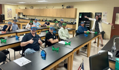 HRA Upper School science teacher Lauren Oaks welcomes families to her classroom with a chemistry demonstration on Back-to-School Night