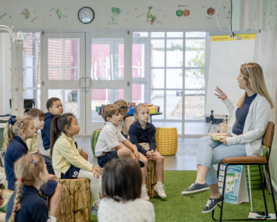 HRA first-grade teacher Staci Lanier with her class in the hydroponics laboratory